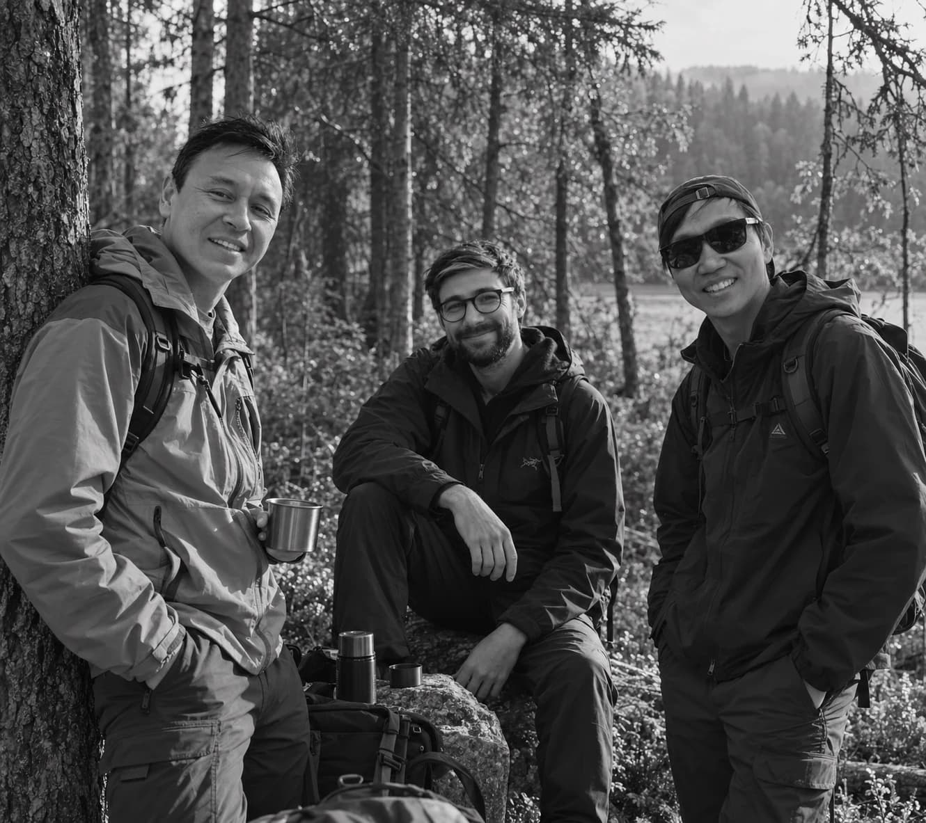 Three people with backpacks in a forest